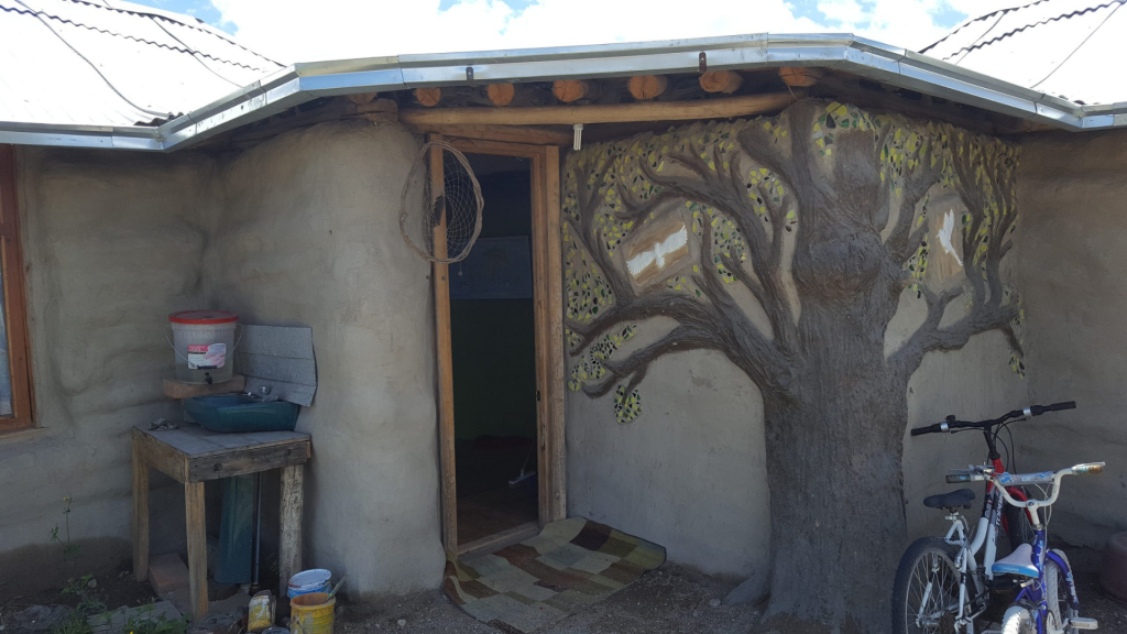 Tree adobe mural at Helens